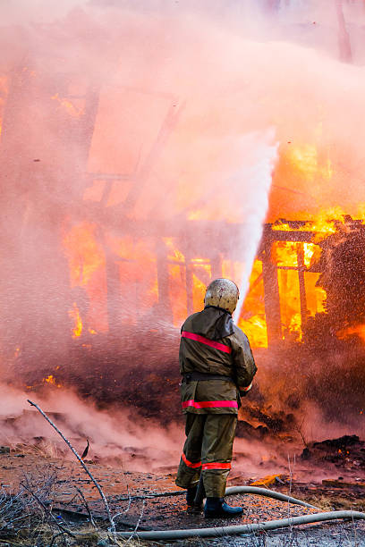 fireman extinguishes incendio - natural disaster fire office fire department fotografías e imágenes de stock