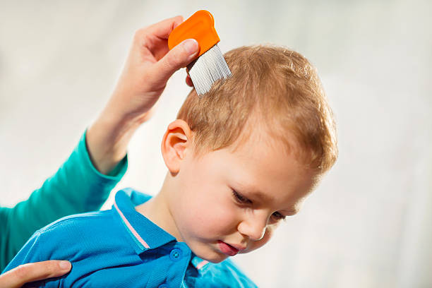 Mother using a comb to look for head lice.