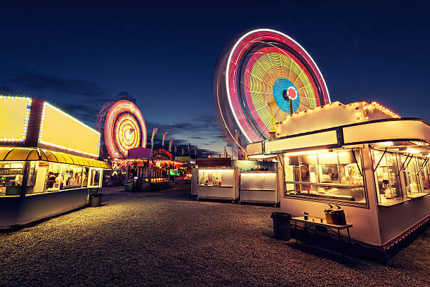 Vacant Carnival A carnival spins into the night with not a soul to be found. Long exposure. food recall stock pictures, royalty-free photos & images
