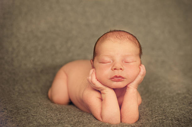 istock Dreaming Naked Newborn Baby Lying on Hands 513381581