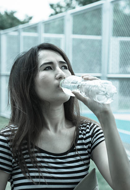 istock girl drinking water 513381891