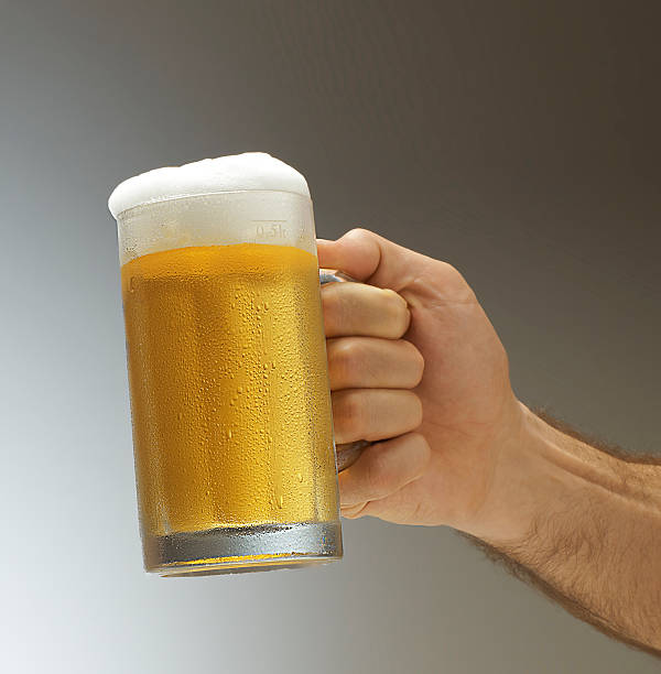 istock masculine male hand toasting beer 513382325
