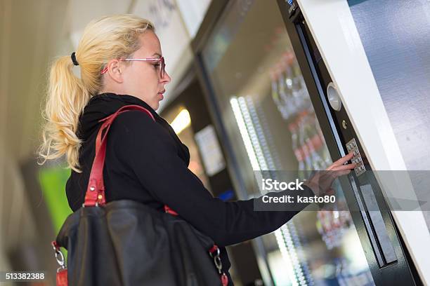 Lady Using A Modern Vending Machine Stock Photo - Download Image Now - Vending Machine, Soda, Drink