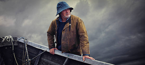 Fisherman Portrait, Stormy Sky and Dory, Nova Scotia stock photo