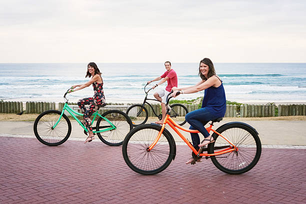 istock Siblings happily cycling alongside each other on the promenade 513382710