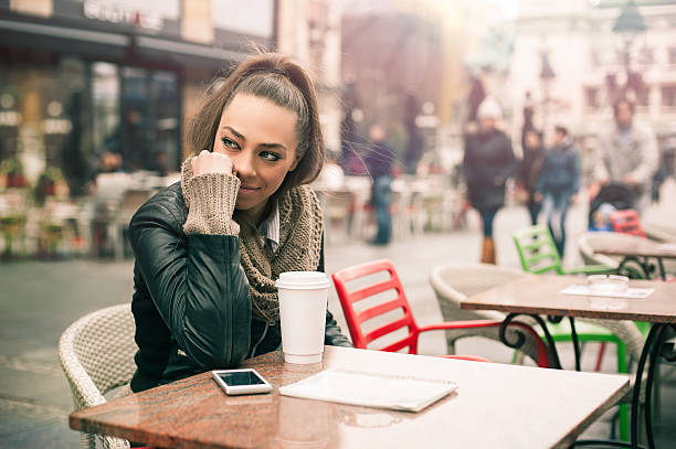istock Beautiful woman drinking coffee at the cafe 513383550