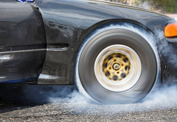 istock Drag racing car burns rubber off its tires 513383634