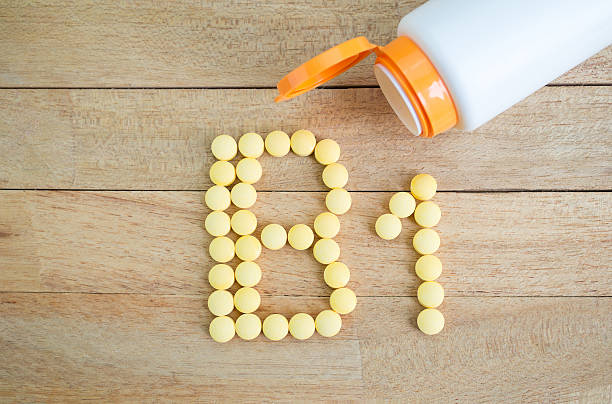 istock Yellow pills forming shape to B1 alphabet on wood background 513383684