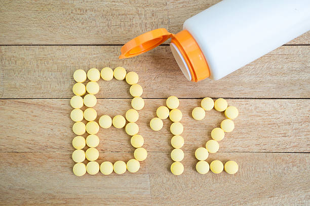 istock Yellow pills forming shape to B12 alphabet on wood background 513384632