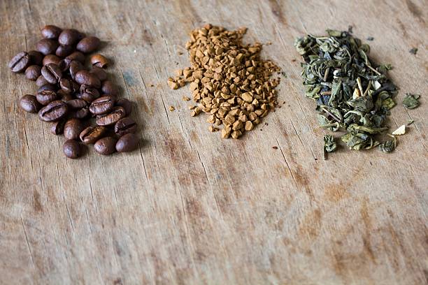istock Coffee beans and green tea leaves 513385260