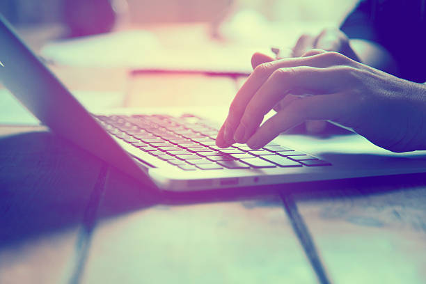 istock Close up of female hands working on a laptop 513385370