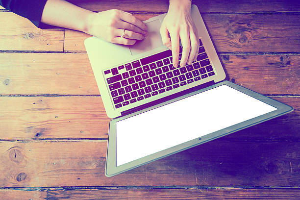 istock Close up of female hands working on a laptop 513385544
