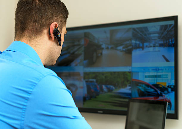 istock Security guard monitoring video in security room. 513386302