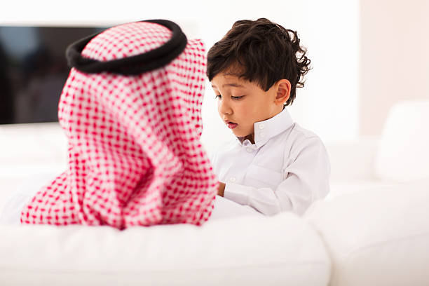little muslim boy and his father stock photo