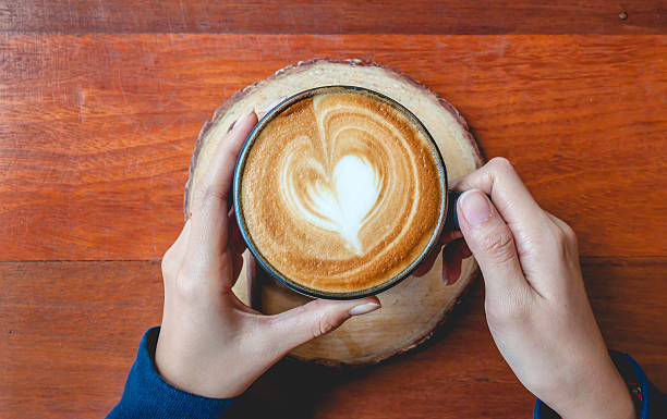 istock Holding a cup of coffee 513387272