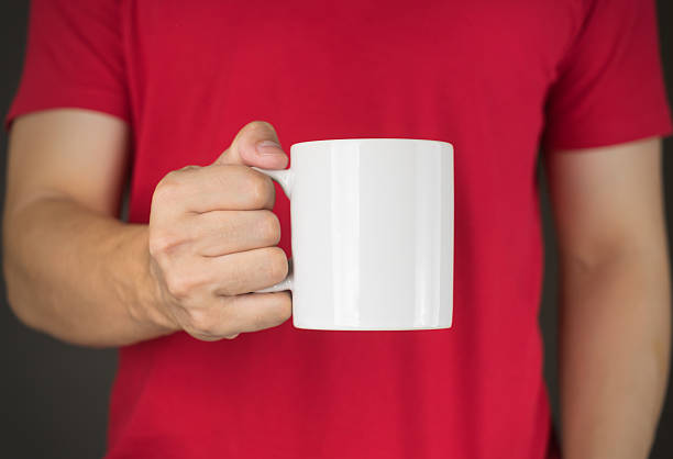 istock Man in red t-shirt holding Coffee mug 513393072