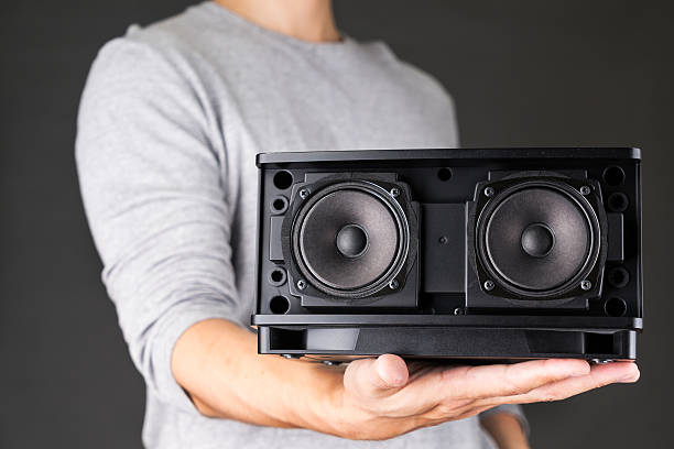 Man Holding Speaker on black background