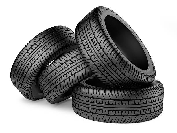 istock Stack of four new black wheel tyres for car 513393464
