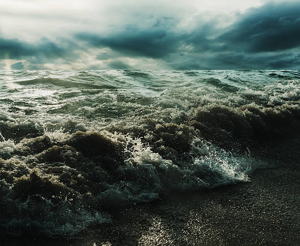 istock Sea and beach storm with sunrays in over dark tone 513393950