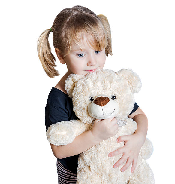 istock Little girl holding a teddy bear 513394022