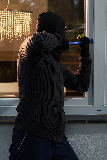 istock Burglar opening the window 513395723