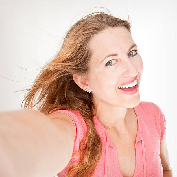 istock Smiling Woman Taking Selfie 513396041