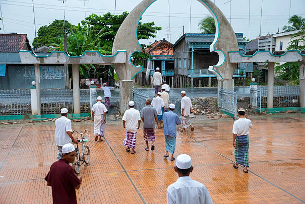 Chau Doc, Vietnam - June 27, 2007: Cham Muslims at the Mubarak Mosque leave after prayers in Chau Giang village in Chau Doc, Vietnam