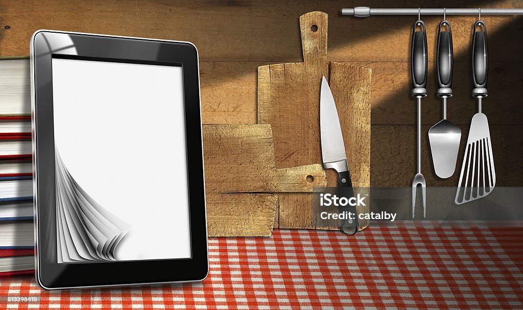 Tablet Computer in the Kitchen Tablet computer with blank pages and stack of books in a kitchen, on wooden wall with kitchen utensils. Template for recipes or food menu Backgrounds Stock Photo