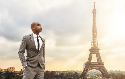 Business man standing against the Tour Eiffel