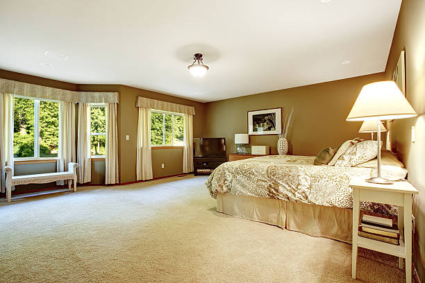 istock Spacious warm bedroom with brown walls 513414427