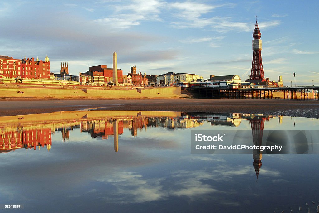 Blackpool North Pier Reflection A beach golden hour calm evening reflection of the world famous Blackpool Tower and North Pier on the Lancashire Riviera Blackpool Stock Photo
