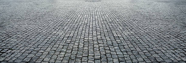 piedra de pavimento en perspectiva - cobblestone fotografías e imágenes de stock