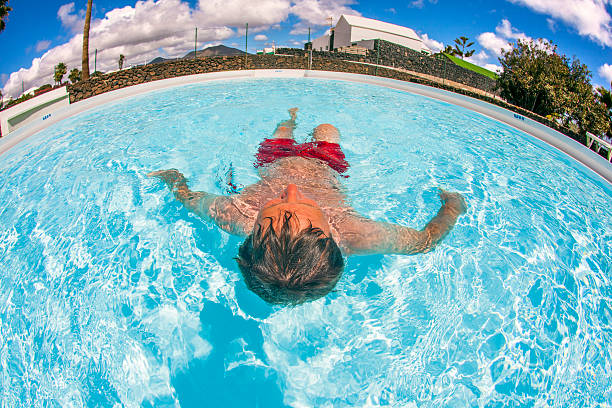 istock attractive man enjoys swimming in the pool 513416183