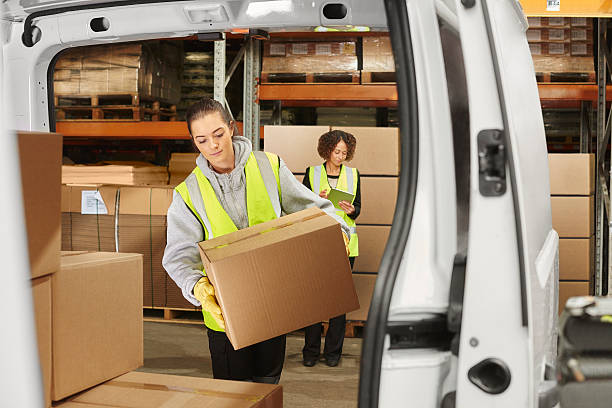 istock female courier filling her van 513416828
