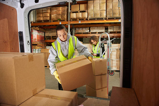 istock female courier filling her van 513417176
