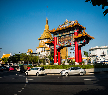Bangkok, Thailand - February 5, 2016: Traffic at the Chinese Gate Bangkok Thailand. This landmark is very close to the Wat Traimit temple in Chinatown and is one of the iconic landmarks of the city. The Yaowarat road that is the main street of Chinatown starts at this gate. It was built in 1999 to commemorate the King's 72nd birthday.