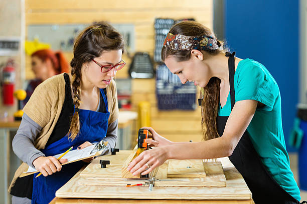 istock Young women working on wood project in workshop or makerspace 513418260