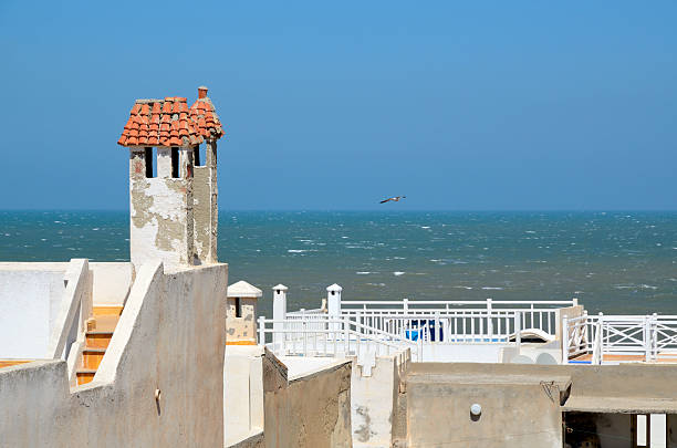 View on Atlantic ocean from roofs of Essaouira white houses in Morocco, North Africa. The old part of town is the UNESCO world heritage sites.