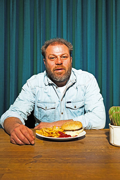 istock Man with beard eating fast food meal. 513419251