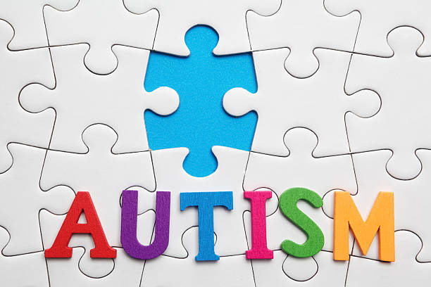 istock Autism inscription on a white puzzle background 513419514