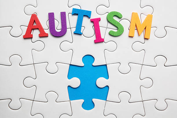 istock Autism inscription on a white puzzle background 513419684