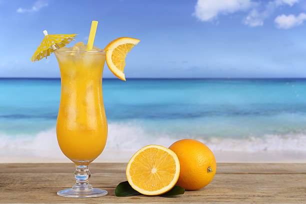 istock Orange juice fruit cocktail on the beach 513419701
