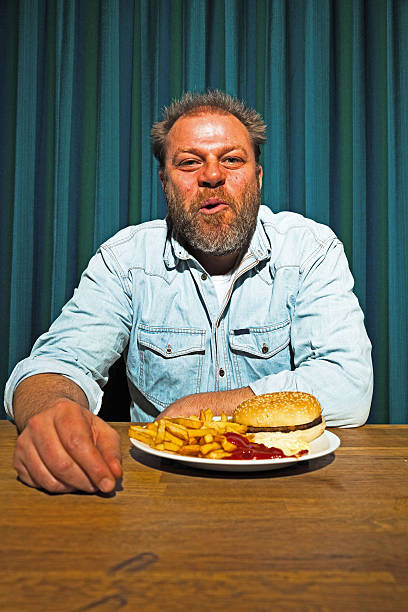 istock Man with beard eating fast food meal. 513419919
