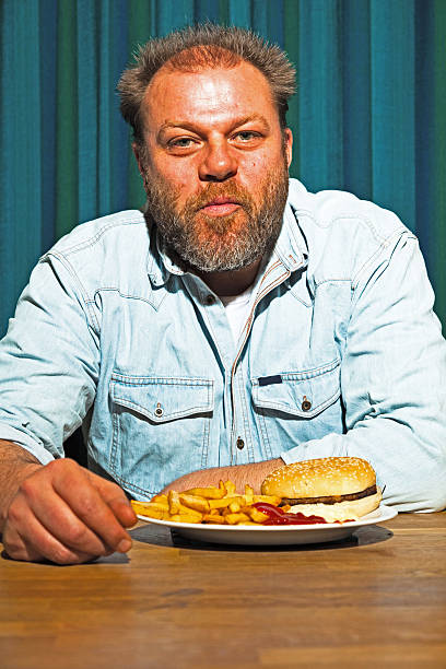 istock Man with beard eating fast food meal. 513420041
