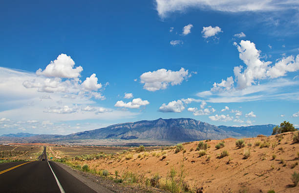 istock White Fluffy Clouds over Southwest Landscape 513420047
