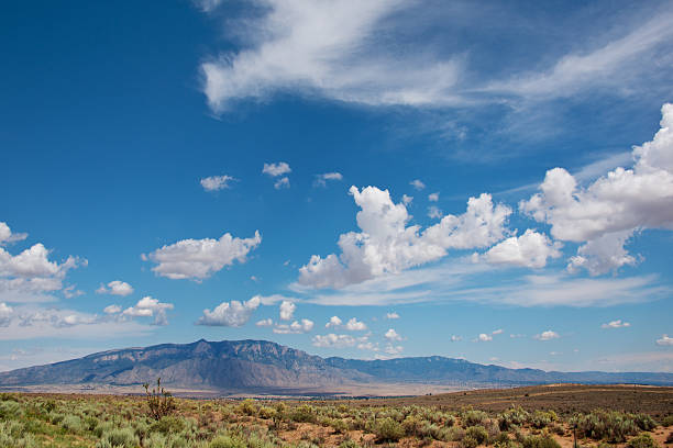 istock White Fluffy Clouds over Southwest Landscape 513420053