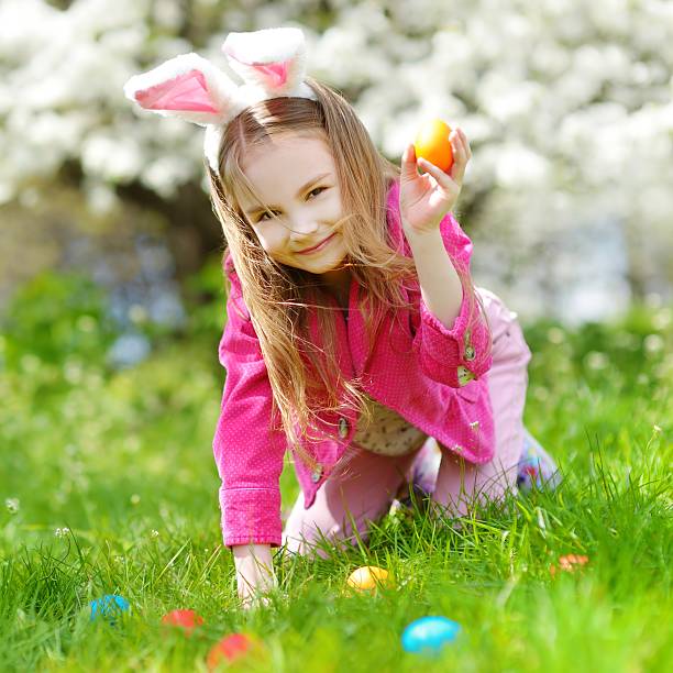 istock Adorable little girl hunting for easter egg on Easter day 513421596
