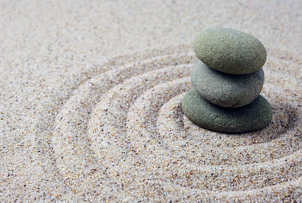 istock Stacked zen stones with spiral sand 513425974