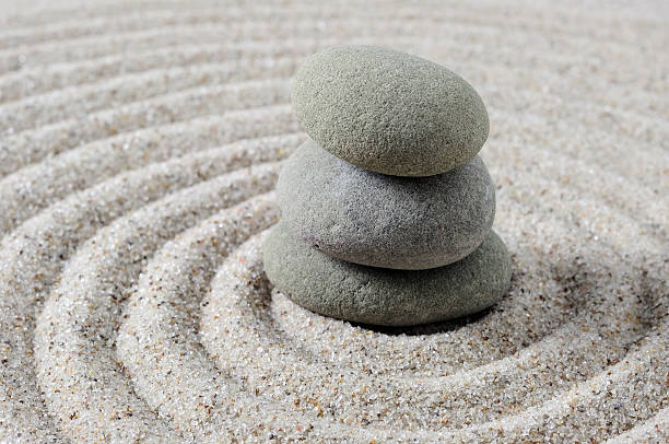 istock Stacked zen stones with swirling sand 513426086