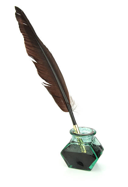 Quill pen in glass ink bottle